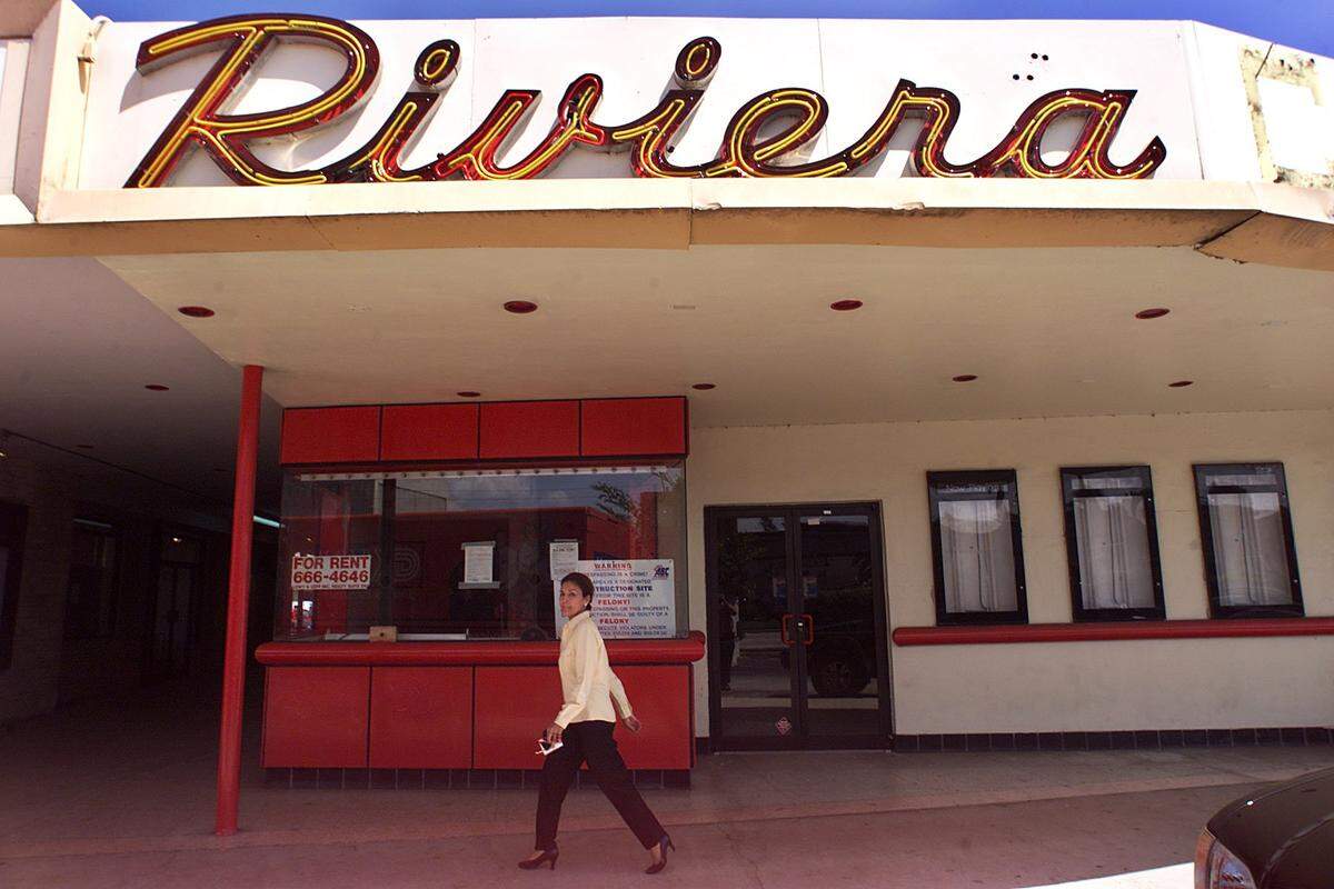 In this file photo from July 5, 2000, a patron of Riviera Plaza strolls by the shuttered Riviera movie theater in Coral Gables that was on on US 1 near the University of Miami. The theater was closed in 1999 shortly after the Shoppes at Sunset Place mall opened with a larger multiplex movie theater.