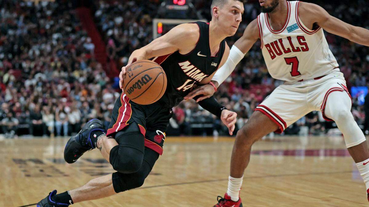 Miami Heat guard Tyler Herro (14) drives as Chicago Bulls forward Troy Brown Jr. (7) defends in the second half at the FTX Arena in Miami on Saturday, December 11, 2021.