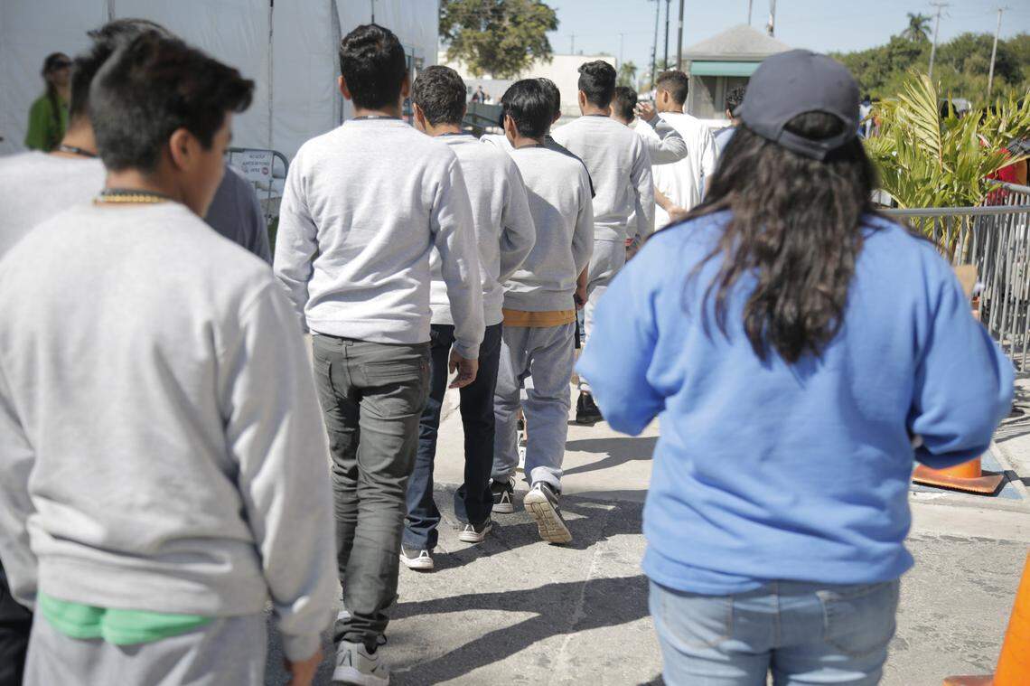 Children walk in a line at the government shelter in Homestead, which houses up to 1,300 children from Central America between the ages of 13 and 17 who came to the United States as undocumented unaccompanied minors.