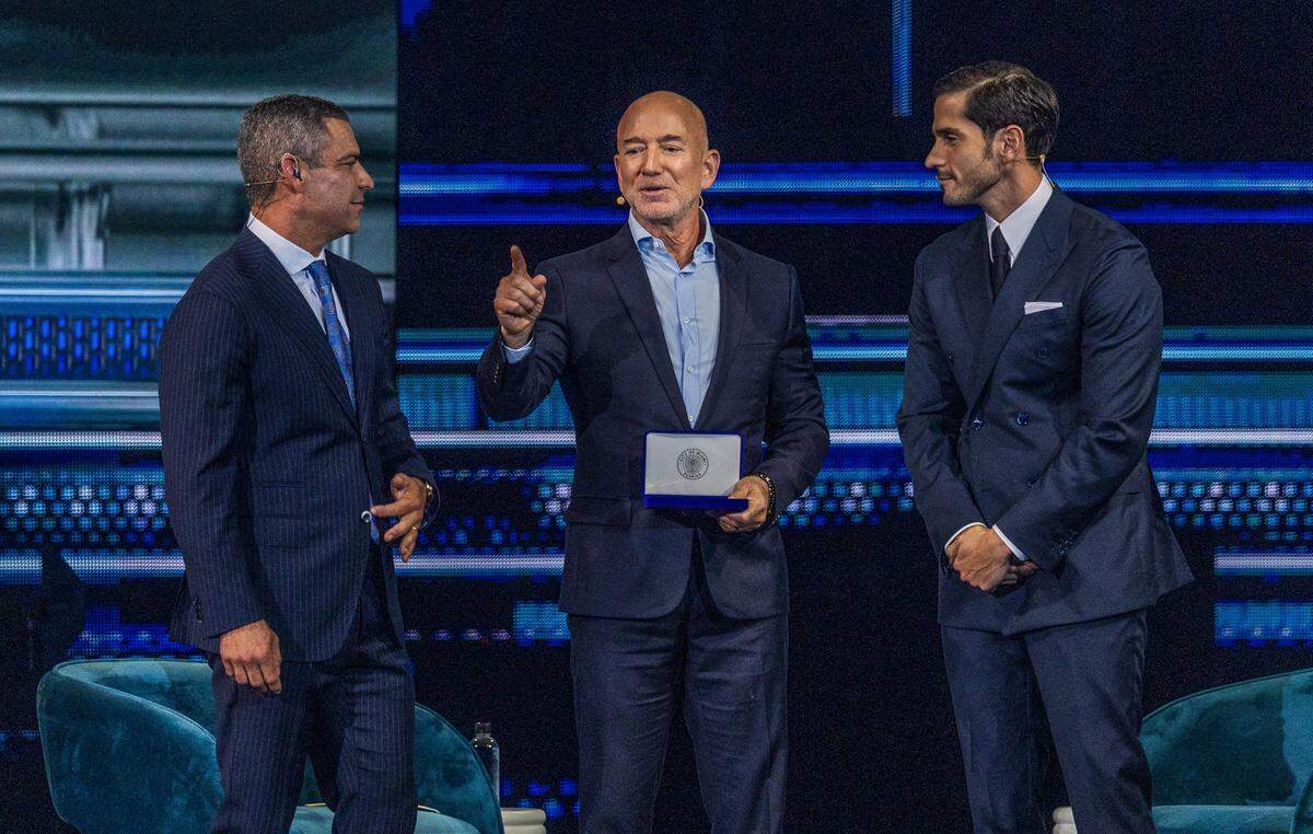 Jeff Bezos after receiving a key to the city of Miami rom Mayor Francis Suarez and Ignacio Gonzalez, right, at the America Business Forum on Thursday.