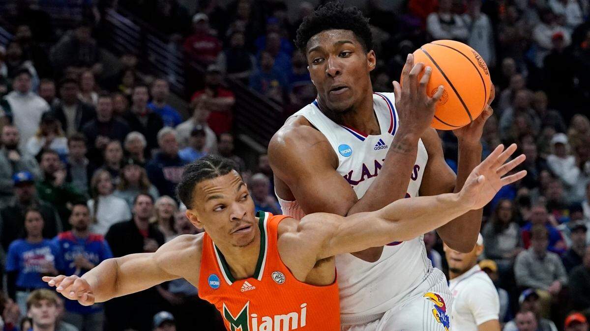 Kansas’ David McCormack tries to get past Miami’s Isaiah Wong during the second half of a college basketball game in the Elite 8 round of the NCAA tournament Sunday, March 27, 2022, in Chicago. (AP Photo/Nam Y. Huh)