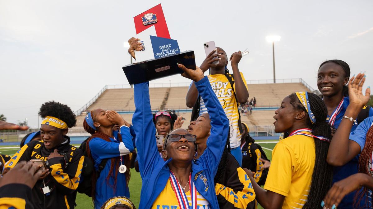 Miami Northwestern Senior High’s Leila Finnie holds the trophy after her and her teammates won the GMAC track and field championship at the Traz Powell Stadium on Thursday, April 11, 2024, in Miami, Fla.