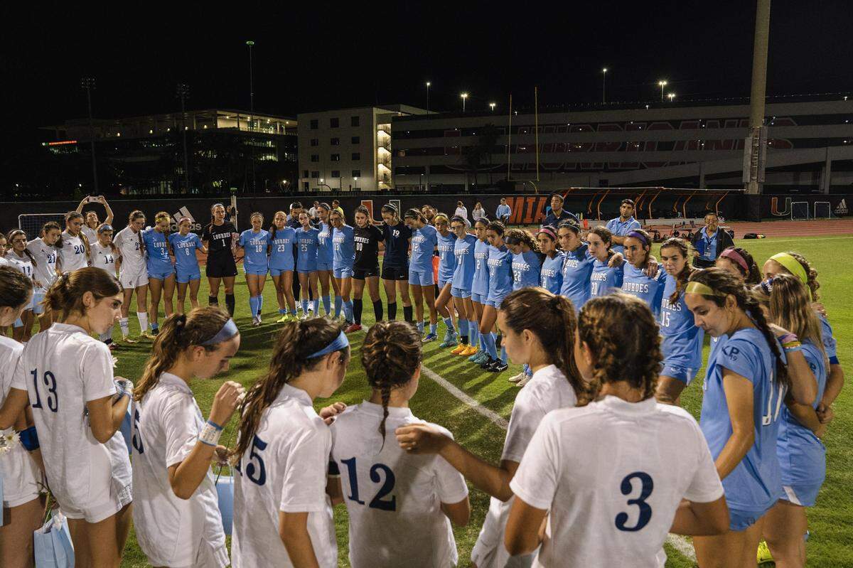 Lourdes and Carrollton soccer players form a prayer circle after playing a recent match the two schools dedicated to the memory of Lourdes student Lucy Fernandez — who was killed in a boat crash in the Keys on Labor Day weekend — and to the recovery of Lourdes soccer star Katy Puig, who has been hospitalized since the crash.