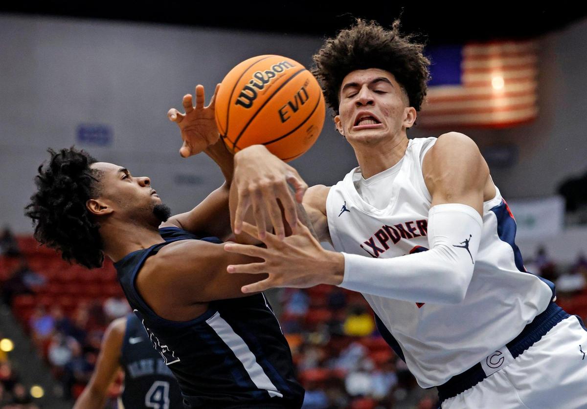 Columbus High School’s Cameron Boozer (12) battles for the ball with Winter Haven’s Kjei Parker (12) during the FHSAA boys basketball Class 7A State Championship at the RP Funding Center in Lakeland, Florida on Saturday, March 4, 2023.