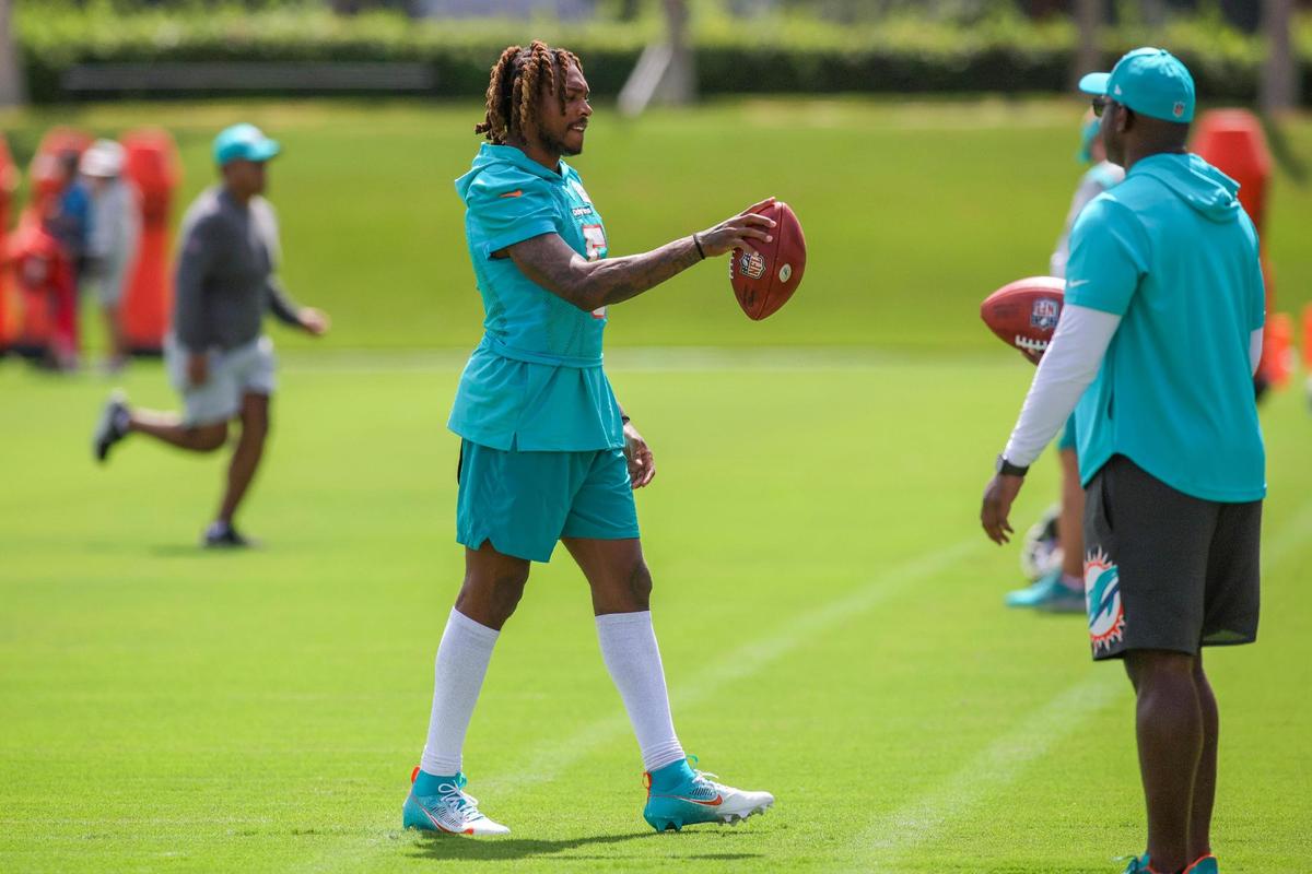 Miami Dolphins cornerback Jalen Ramsey (5) walks on the field with a football during training camp at Baptist Health Training Facility in Miami Gardens, Florida, Thursday, July 27, 2023.