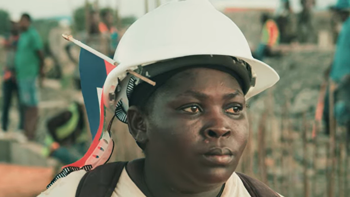 A still shot from the trailer of the documentary The Heroes of the Massacre River shows Milourie Sylfrard, an advocate for the canal and mason who lent her skills to its construction. Sylfrad died in October 2024 and was essential in the building of the canal.