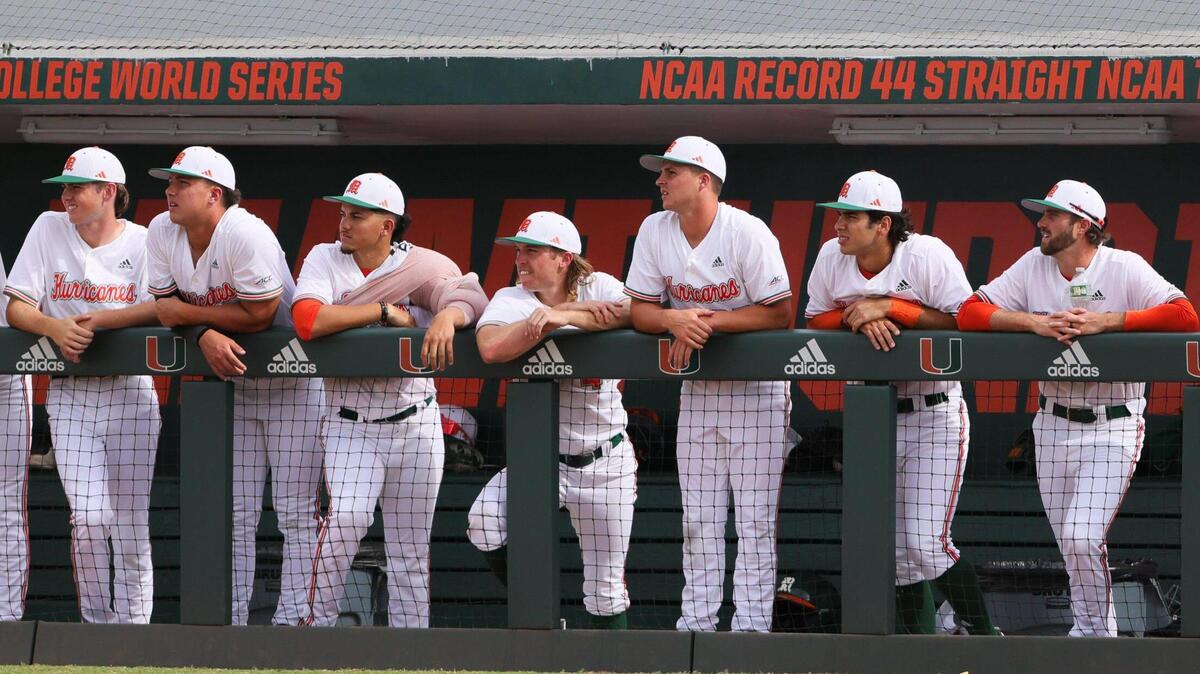 Miami Hurricanes baseball players watch from the dugout against the Florida Gators during the eighth inning at Alex Rodriguez Park at Mark Light Field in Coral Gables, Florida, Sunday, March 3, 2024.
