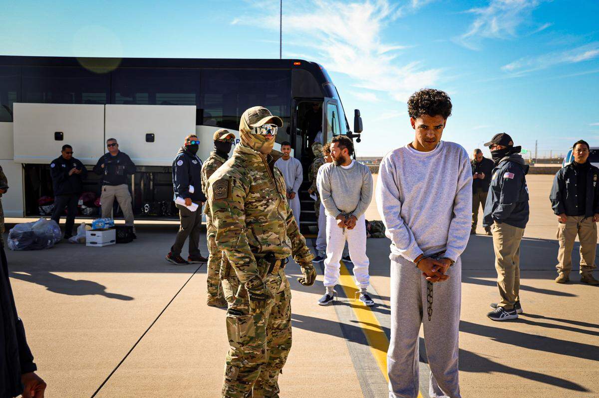 Mayfreed Duran Arape, 21, arrives in Guantanamo, among the first group of Venezuelan migrants transfered to the military base. His family said they recognized him from this photo. He is pictured as the second man getting off the bus, mostly covered by the man in front of him.