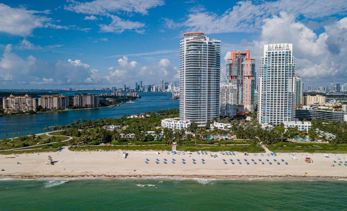 Some of Miami-Dade County’s most valuable property, as seen on Oct. 12, 2022, is highly vulnerable to hurricane storm surge along the coastlines of Miami Beach and Biscayne Bay. An aerial view of Miami Beach’s South Pointe neighborhood, with Fisher Island at left and downtown Miami and Brickell in the far background, shows how dense high-rise development has put tens of thousands of new residents in high-hazard surge zones in the past 20 years.