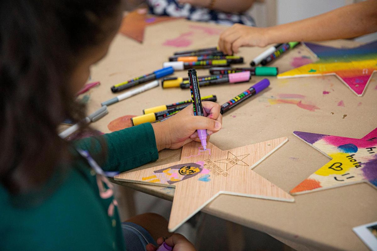 Children decorate wooden stars for the Miami Children’s Museum’s Stars of Hope project in Miami on Tuesday, Jun. 14, 2022.