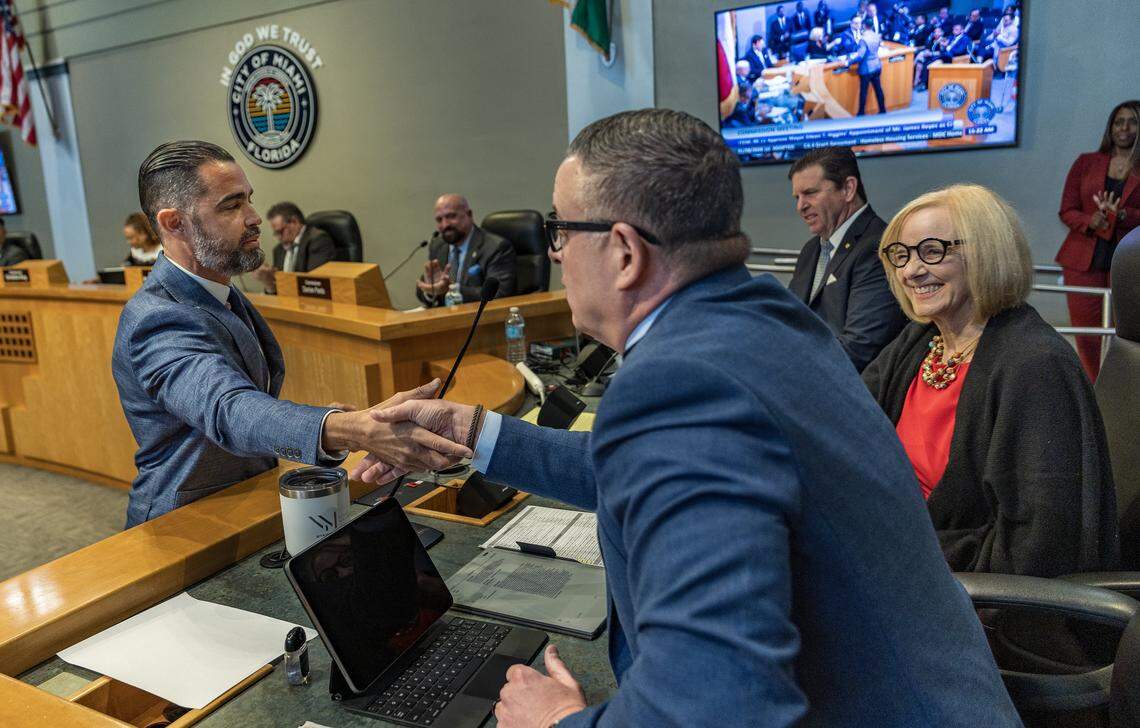 James Reyes (left), the newly appointed City Manager named Mayor Eileen Higgins, shakes hands with the outgoing City Manager Art Noriega, during the first Miami City Commission meeting of 2026, at City Hall, on Thursday January 08, 2026.
