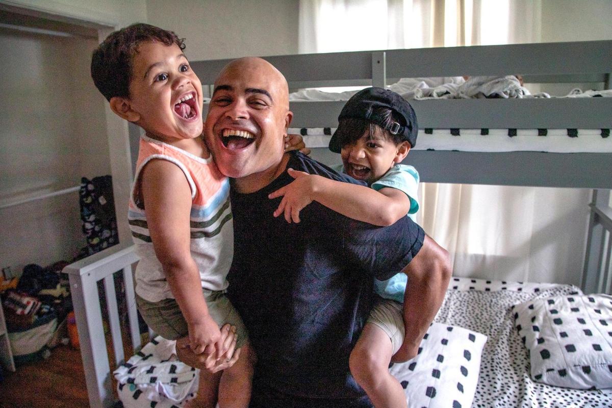 Musical artist Danny Flores plays with his children, Noah (Arc) Flores, 3, at left, and Lucas Flores, 5, at right, on Wednesday, in their Coral Gables home.