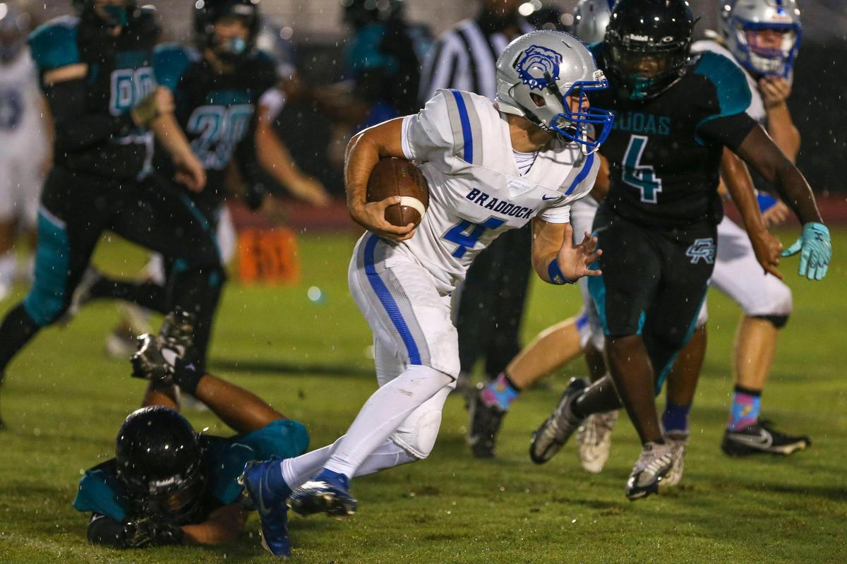 Braddock quarterback David Garcia (4) runs with the football during the first half of a high school football game against Coral Reef at Southridge Park in Miami, Florida, Thursday, September 15, 2022.