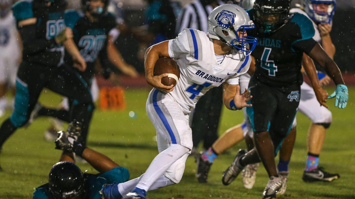 Braddock quarterback David Garcia (4) runs with the football during the first half of a high school football game against Coral Reef at Southridge Park in Miami, Florida, Thursday, September 15, 2022.