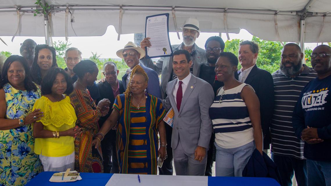 Members of the team that advocated for creation of a civil rights museum at Historic Virginia Key Beach Park pose for a picture with Miami Mayor Francis Suarez, front center, in 2019. Trust board member Gene Tinnie holds aloft Suarez’s resolution pledging financial support.
