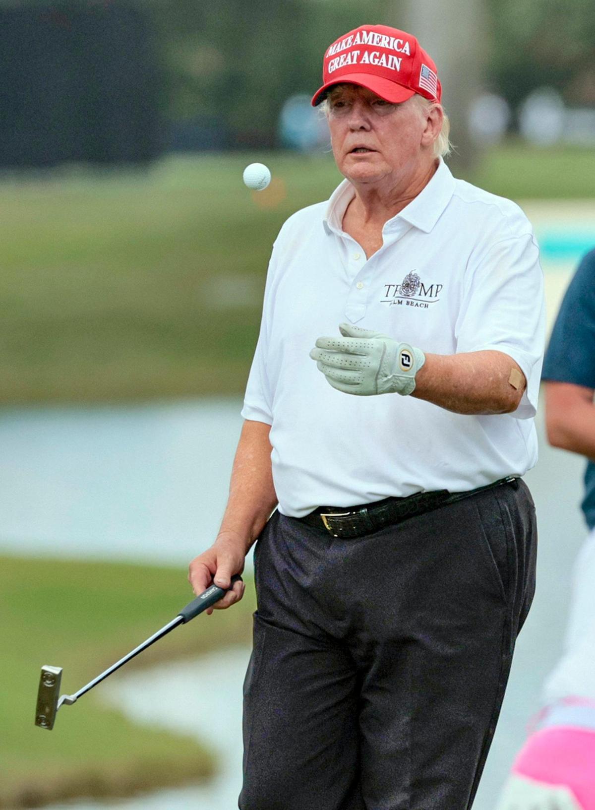Former President Donald Trump tosses the ball during the LIV Golf Miami Team Championship Pro-Am Tournament at Trump National Doral Golf Club in Doral on Thursday, October 27, 2022.