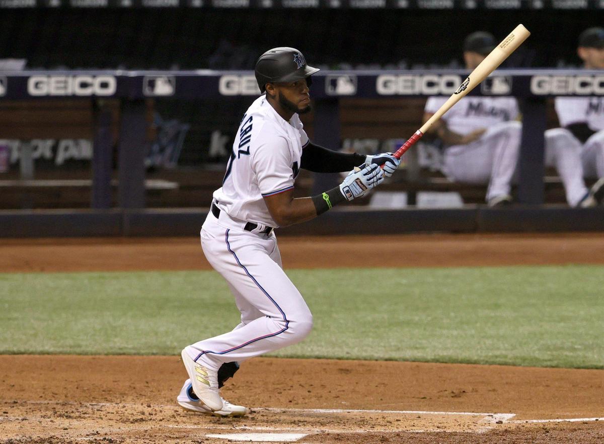 Miami Marlins left fielder Bryan De La Cruz (77) hits a single during the second inning of their baseball game at loanDepot park on Thursday, August 26, 2021 in Miami, Florida.