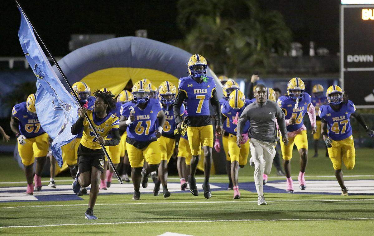 Northwestern team take the field for the game against Palmetto on Friday, October 17, 2025 at Traz Powell Stadium in Miami. Andrew Uloza / for Miami Herald