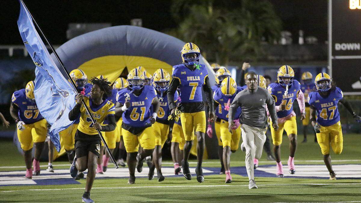 Northwestern team take the field for the game against Palmetto on Friday, October 17, 2025 at Traz Powell Stadium in Miami. Andrew Uloza / for Miami Herald