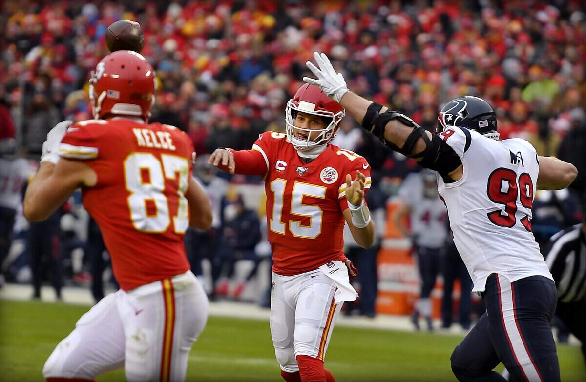 Kansas City Chiefs quarterback Patrick Mahomes gets off a pass to tight end Travis Kelce despite the rush of Houston Texans defensive end J.J. Watt Sunday, January 12, 2020, at Arrowhead Stadium in Kansas City, Missouri.
