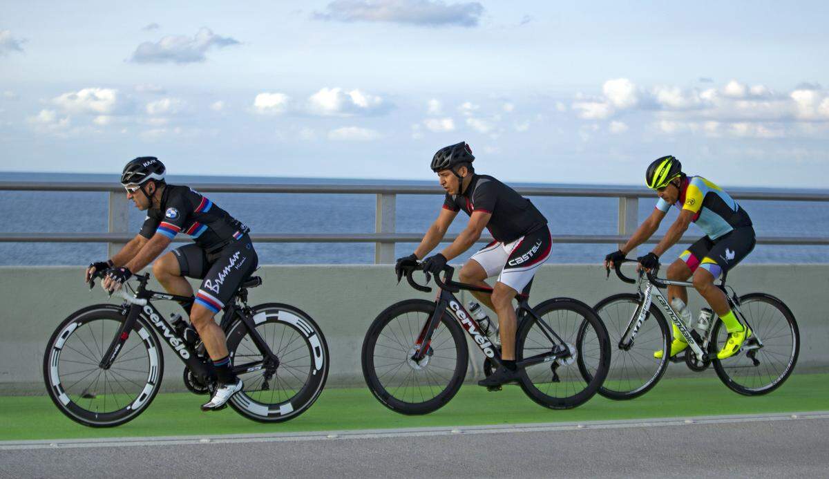 A group of cyclists ride over the Rickenbacker Causeway as the coronavirus pandemic continues on Sunday, April 5, 2020, in Key Biscayne.