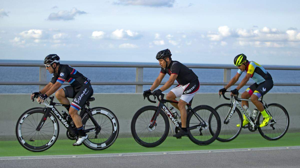 A group of cyclists ride over the Rickenbacker Causeway as the coronavirus pandemic continues on Sunday, April 5, 2020 in Key Biscayne.