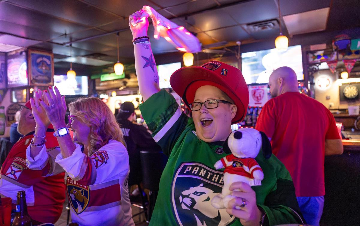 Florida Panthers fan Ashley Miller waves a towel after her team scored against the Edmonton Oilers in Game 2 of the NHL Stanley Cup Final at the Inn Field Bar & Grill on Friday, June 6, 2025, in Sunrise, Fla.