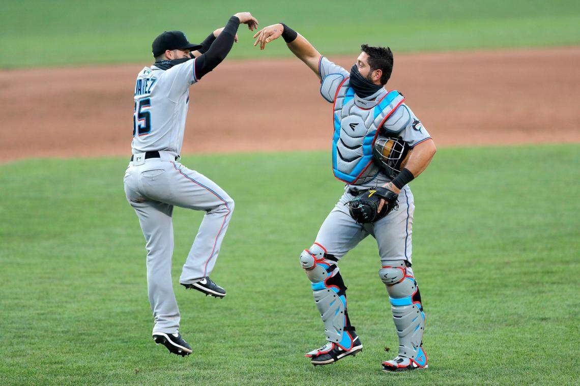 Miami Marlins catcher Francisco Cervelli, right, and second baseman Eddy Alvarez celebrate after defeating the Baltimore Orioles 1-0 during game one of a baseball double-header, Wednesday, Aug. 5, 2020, in Baltimore.