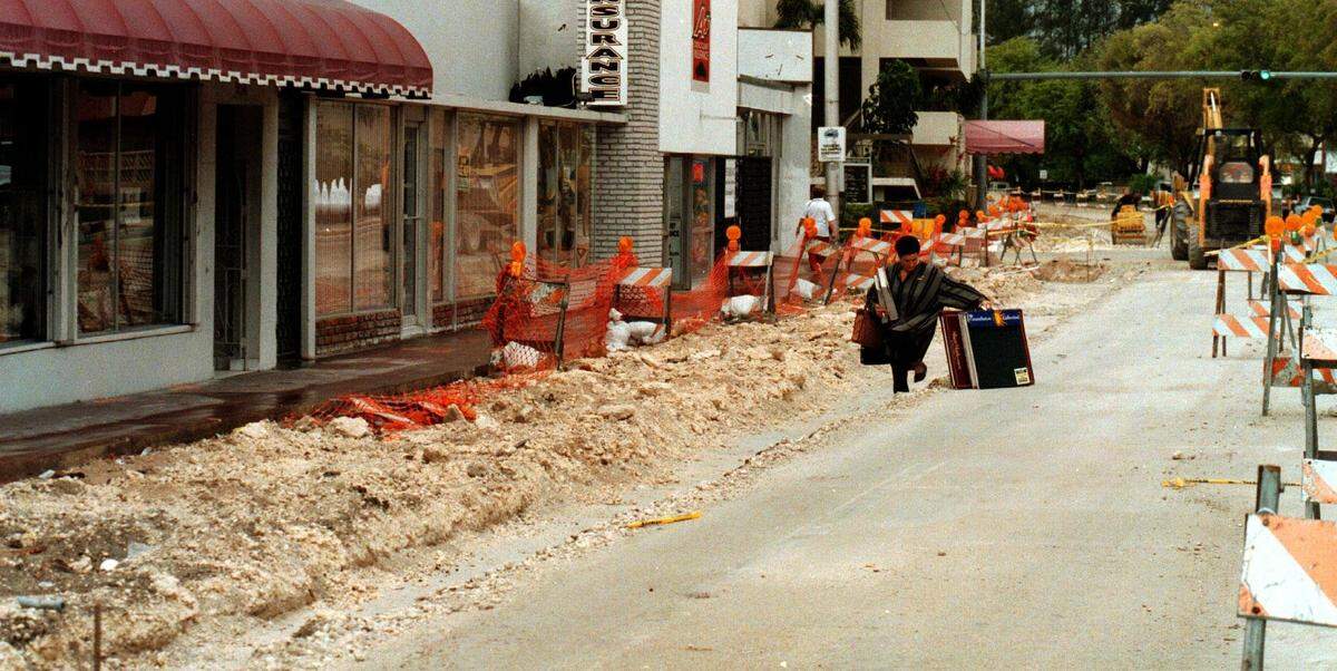 In j1997, Carla Oxios steps into the ditch in front of her shop on the main street heading west on Normandy Drive.