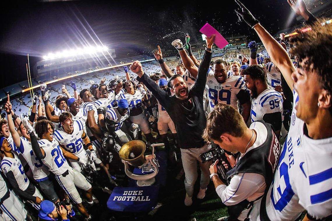 CHAPEL HILL, NORTH CAROLINA - NOVEMBER 22:  Manny Diaz of the Duke Blue Devils rings the bell for a win after the second half of the game against the North Carolina Tar Heels at Kenan Memorial Stadium on November 22, 2025 in Chapel Hill, North Carolina. (Photo by Jaylynn Nash/Getty Images)