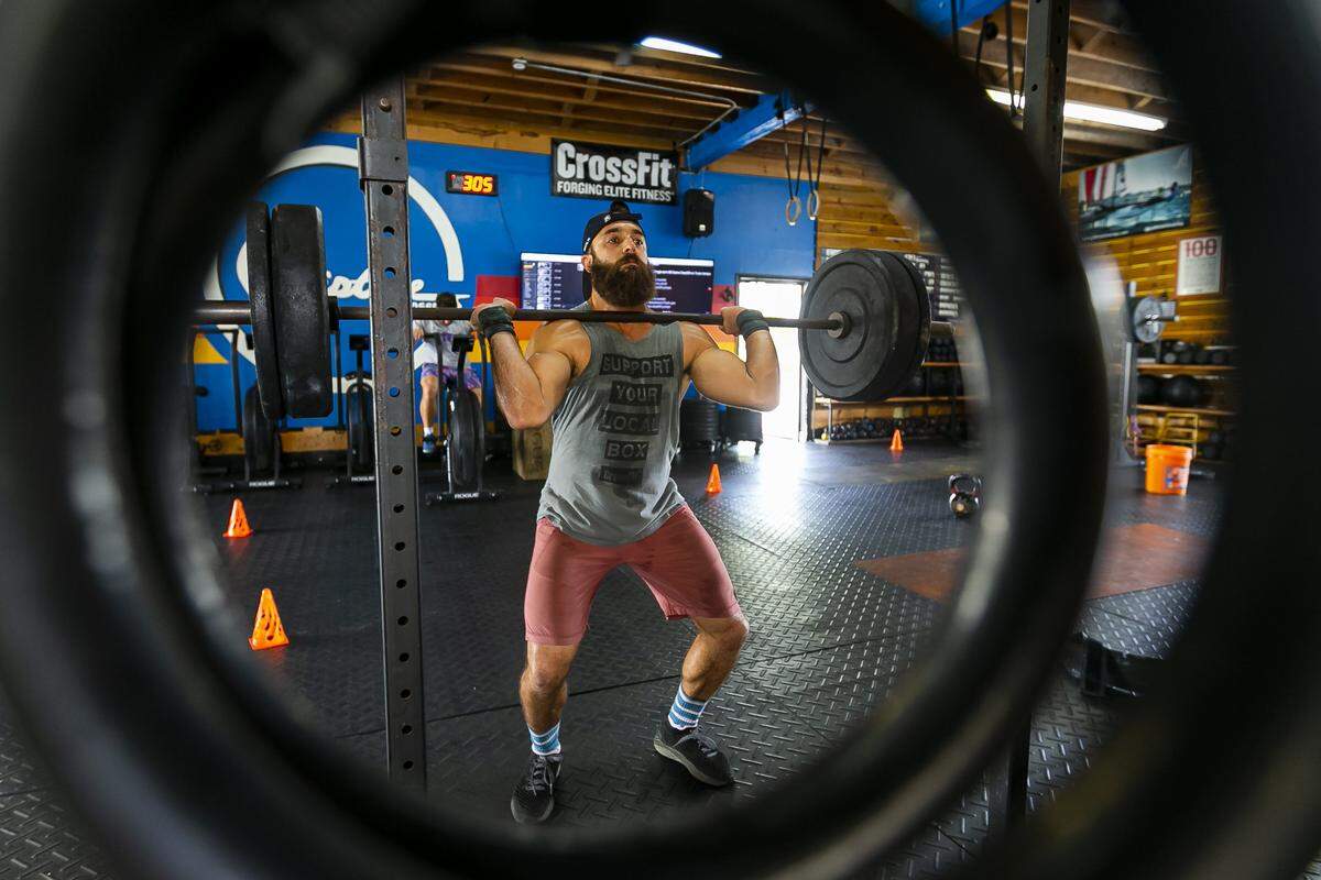 Santiago Callejas, 36, owner of Riptide CrossFit in Fort Lauderdale, works out at his gym on Tuesday.