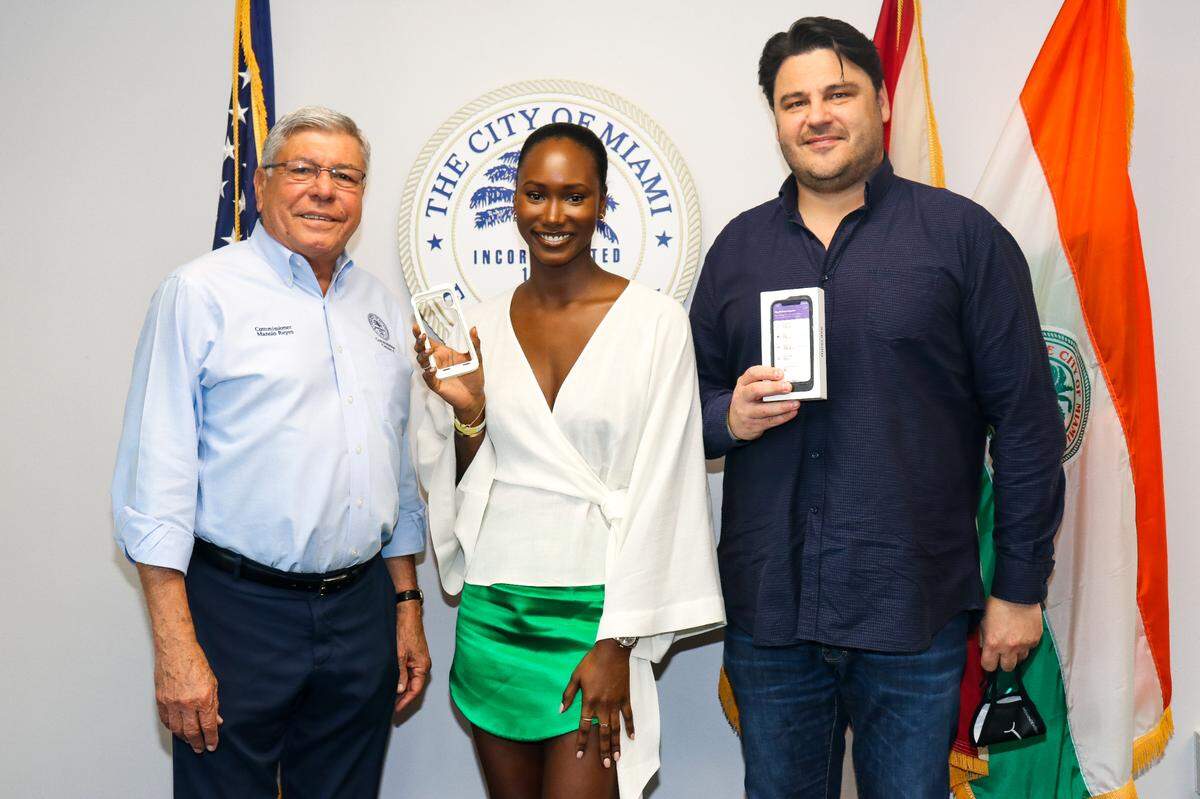 Moscase co-founders Chanteva Schoch, center, and Akos Balogh pose with Miami Commissioner Manolo Reyes. Moscase hopes to create dozens of jobs in downtown Miami to build out its unique iPhone cases.