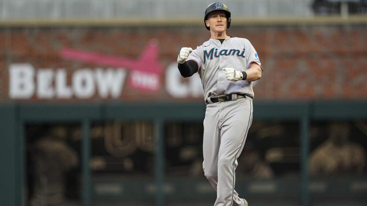 Miami Marlins designated hitter Garrett Cooper (26) reacts after hitting a double and driving in the tying and go ahead runs against the Atlanta Braves during the ninth inning at Truist Park on Thursday, April 27, 2023.