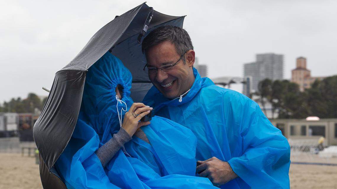 Brazilian tourists Juliana Steck, 32, and Mauro Jucewicz, 46, used ponchos to stay dry last month during the Hyundai Air & Sea Show in Miami Beach, which had its fourth wettest May on record. Statewide, average rainfall broke a record set in 1895.