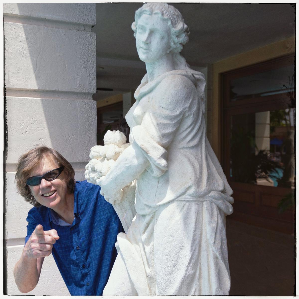 Thurston Moore, co-founder of the innovative and influential indie-rock band Sonic Youth, peeks out from behind a poolside statue at the Biltmore Hotel in Coral Gables. Moore, a Gables native, now spends winters in the city of his birth.