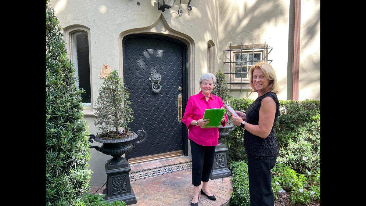 Villager House Tour Chair Marlin Ebbert and Villager President Susan Medina check out the logistics at a 1920s French Country Village home in preparation for the 2022 Historic House Tour.