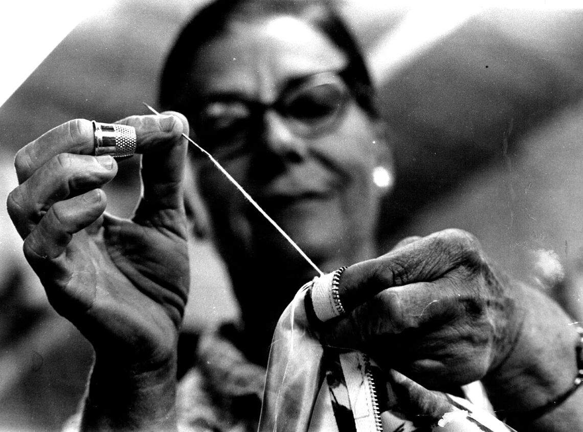 A worker sews garments in the Miami district.