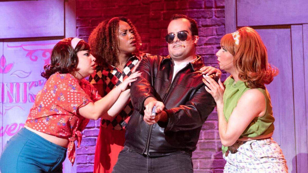 The girl group Urchins surround Frank Montoto’s sadistic dentist in Loxen Productions’ “Little Shop of Horrors” at the Manuel ARTime Theater.
