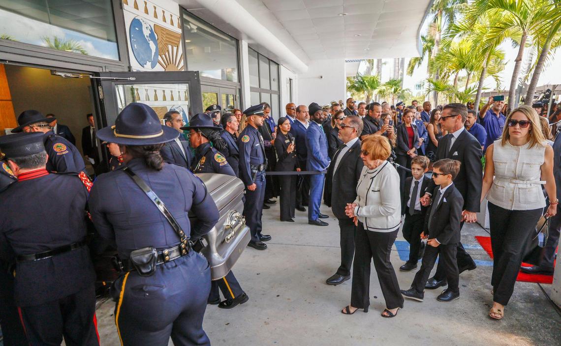Chacha Reyes, at center, the wife of Miami City Commissioner Manolo Reyes, who died on Thursday, and family members follow the casket as it arrives for a memorial service at Miami City Hall on Wednesday, April 16, 2025.