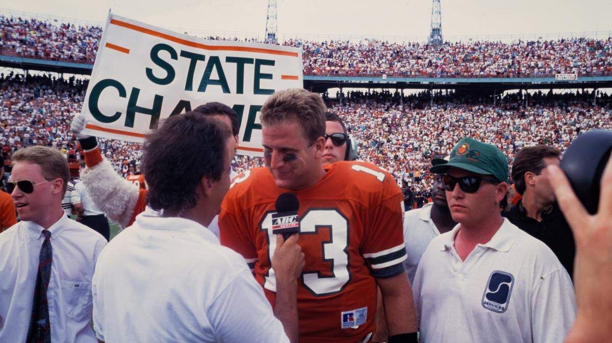 1992 Miami Hurricanes Football: UM quarterback Gino Torretta is shown after win vs. FSU talking to sideline reporter.