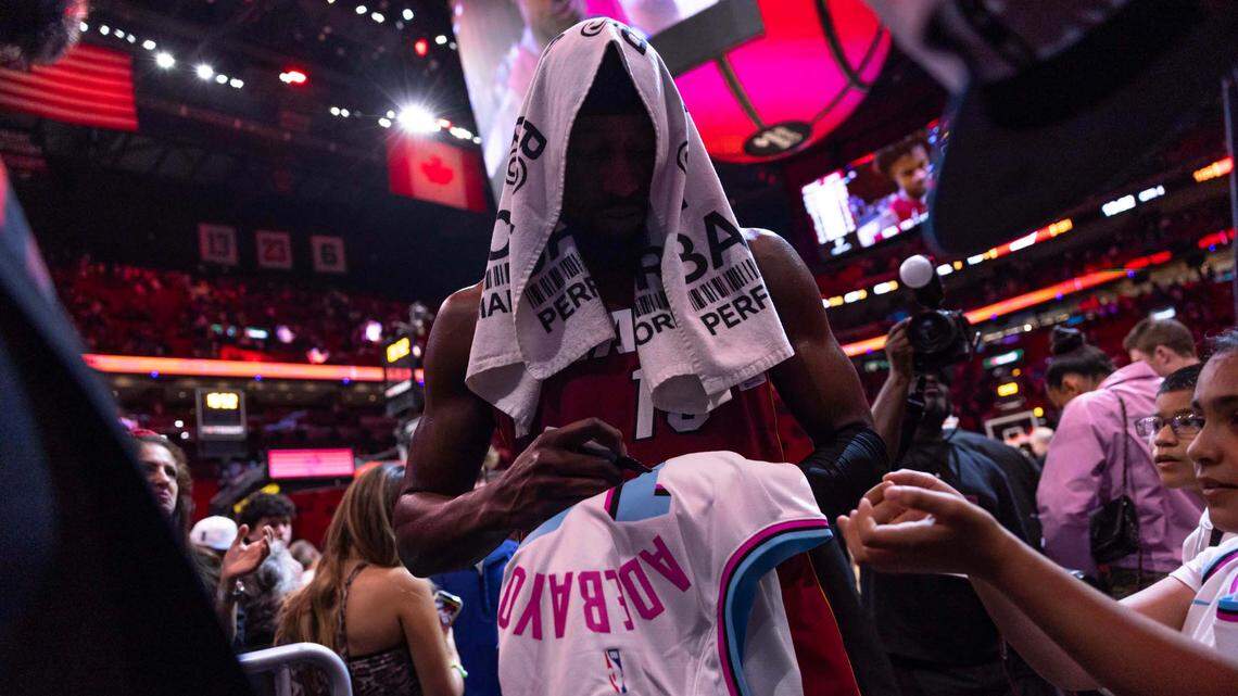 Miami Heat center Bam Adebayo (13) signs a jersey for a fan after his team defeated the Atlanta Hawks 131-109 during an NBA game on February 26, 2025, in Miami.