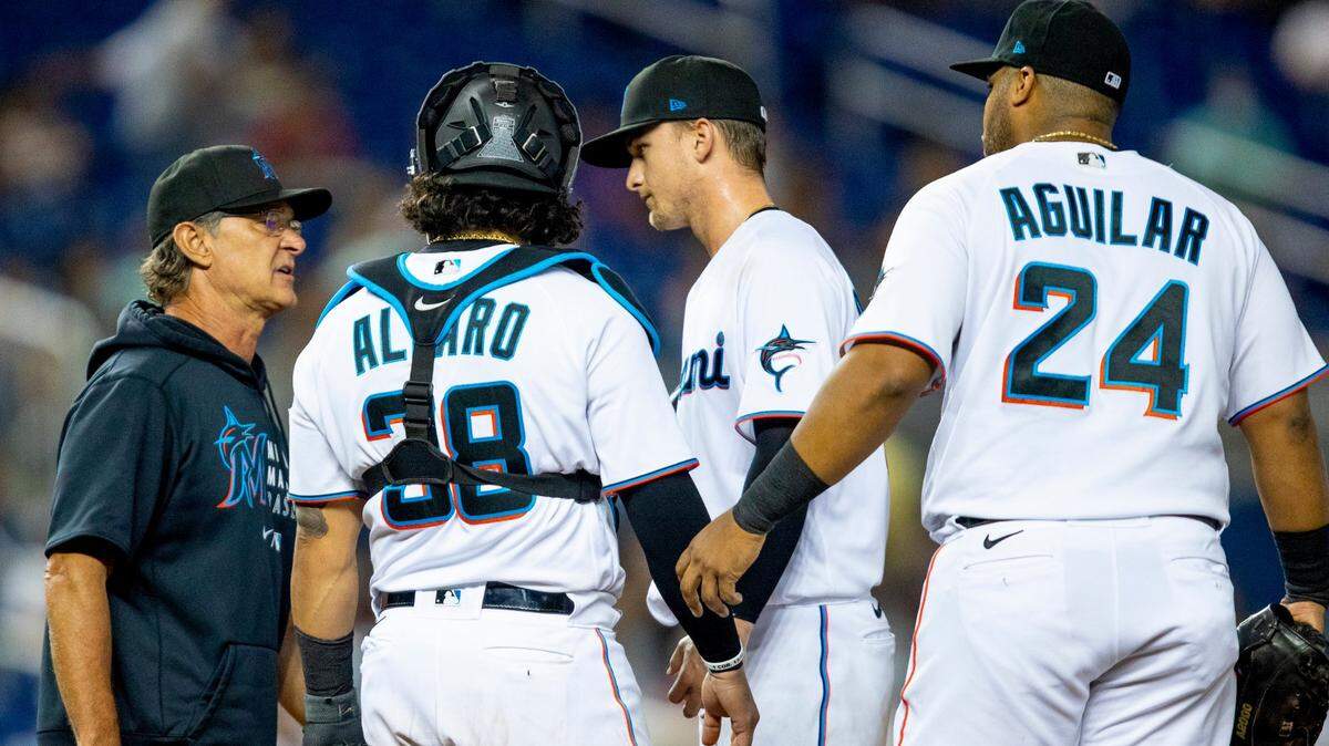 Miami Marlins manager Don Mattingly visits the mound to retire pitcher Braxton Garrett (60) during the fourth inning of an MLB game against the Atlanta Braves at loanDepot park in the Little Havana neighborhood of Miami, Florida, on Monday, August 16, 2021.