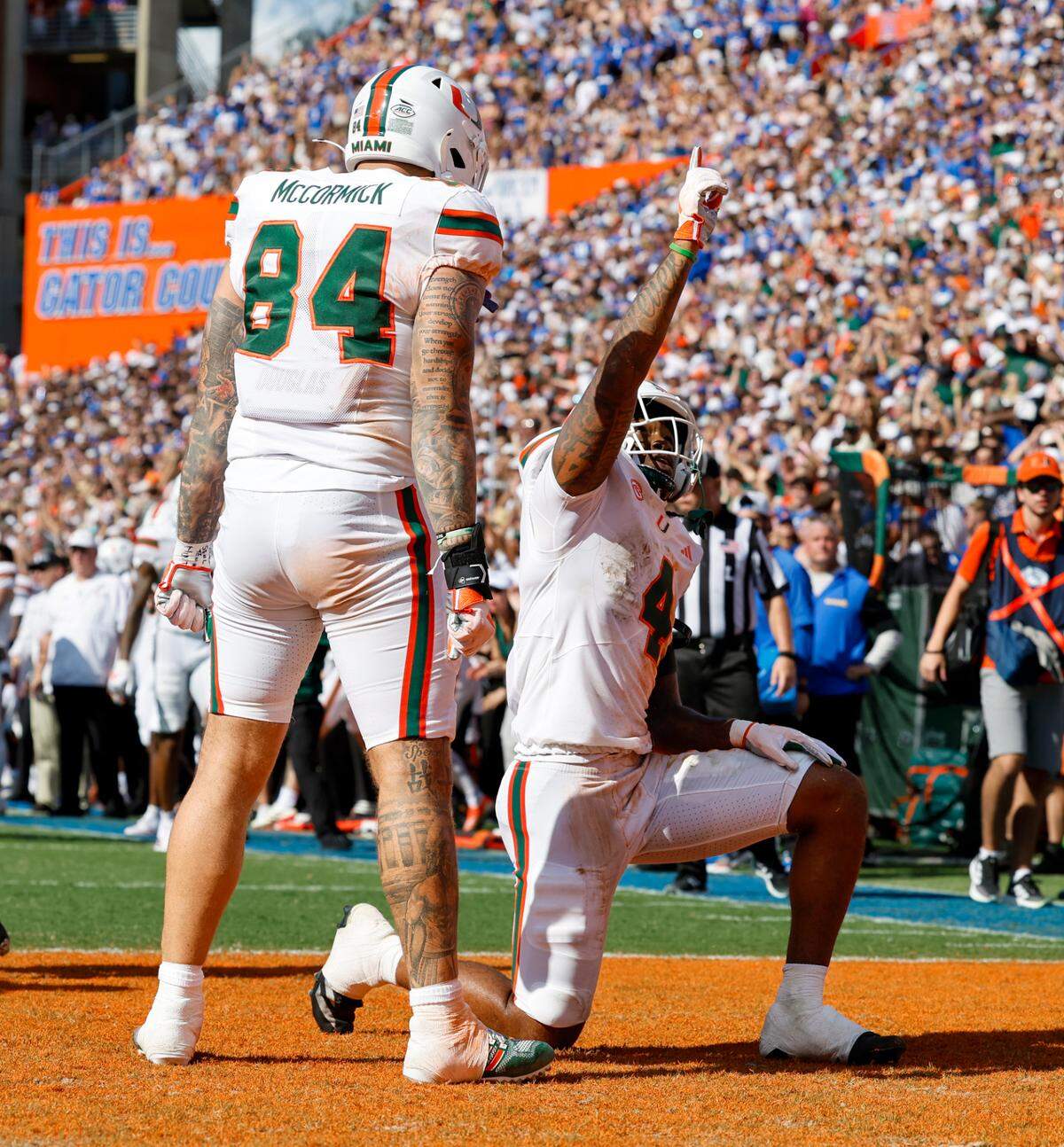 Miami Hurricanes running back Mark Fletcher Jr. (4) celebrates with teammate McCormick (84) after scoring a touchdown during the second half of an NCAA college football game against the Florida Gators at Ben Hill Griffin Stadium in Gainesville, Florida, on Saturday, August 31, 2024.
