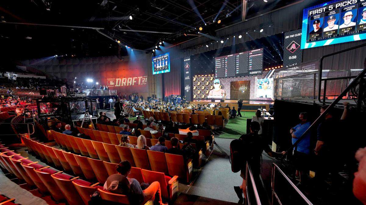 Fans watch during the first round of the 2021 MLB baseball draft, Sunday, July 11, 2021, in Denver.