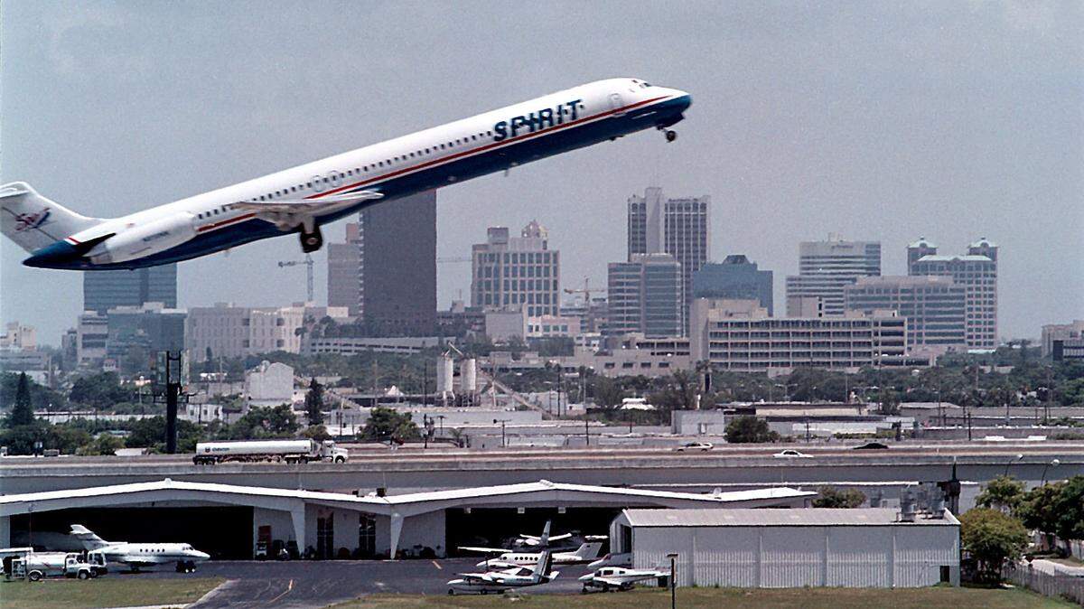 With the Fort Lauderdale skyline in the background, a Spirit Airlines jet takes off from Fort Lauderdale-Hollywood International Airport on July 26, 2000.