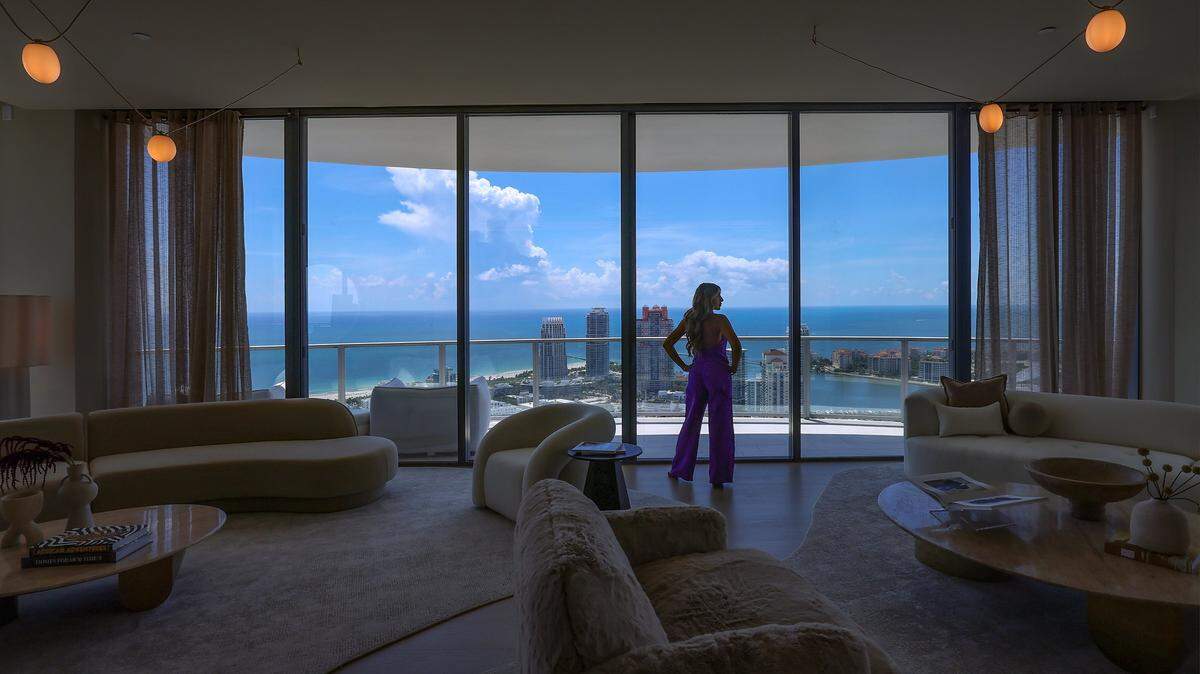 Daniela Alexandre takes in the view as she tours one of her current listings, valued at $21 million at the Five Park luxury residential tower on Tuesday, August 20, 2025, in Miami Beach, Florida. Daniela became a real estate agent a year and a half ago, and currently works at Douglas Elliman.