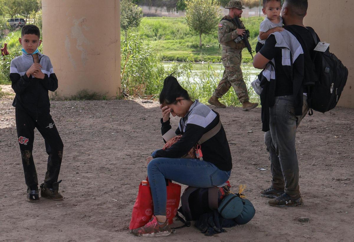 Tras completar el arduo viaje desde Venezuela hasta el puesto fronterizo entre México y Estados Unidos de Eagle Pass, una mujer que dio su nombre como Carolina espera a los agentes fronterizos el domingo 18 de septiembre de 2022.