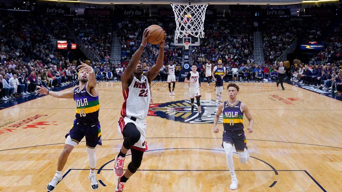 Miami Heat forward Jimmy Butler (22) goes to the basket ahead of New Orleans Pelicans guard Jose Alvarado (15) and guard Dyson Daniels (11) in the first half of an NBA basketball game in New Orleans, Wednesday, Jan. 18, 2023.