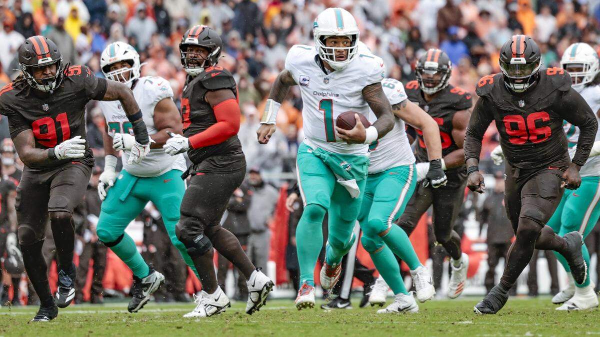 Miami Dolphins quarterback Tua Tagovailoa (1) carries the ball in the first half of an NFL football game against the Cleveland Browns at Huntington Bank Field in Cleveland, Ohio, on Sunday, October 19, 2025.