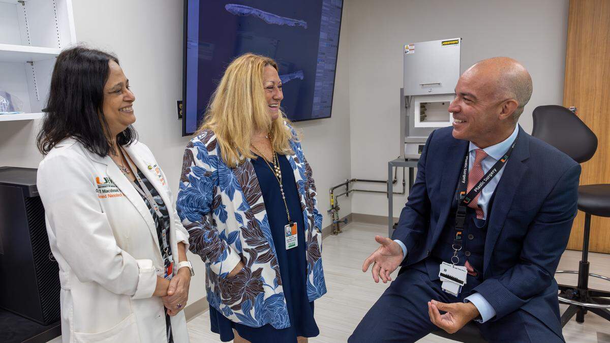 Sapna Deo, left, professor of biochemistry and molecular biology; Sylvia Daunert, center, professor and chair of biochemistry and molecular biology at the University of Miami Miller School of Medicine; and Dr. Paulo Coelho, right, who leads research initiatives at the Miller School of Medicine that drive the 3D-bioprinting facility, converse at the 3D Bioprinting Facility at the University of Miami Miller School of Medicine in Miami on Tuesday, June 2, 2026.